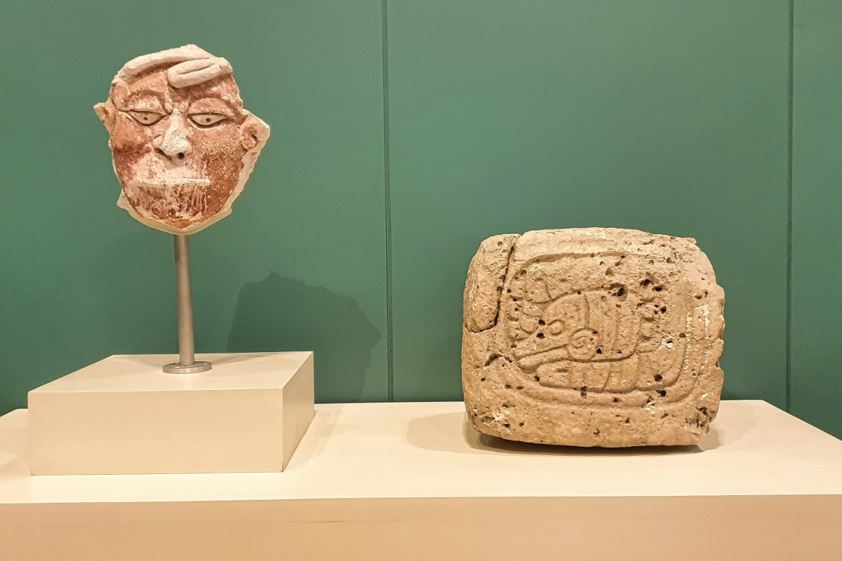 Cancún, México, 18 de octubre de 2024 estuco máscara policromada de un cautivo con labios cosidos del sitio maya Dzibanche y tableta con un glifo Ajaw de El Resbalon en el Museo de Maya, Cancún, México, México